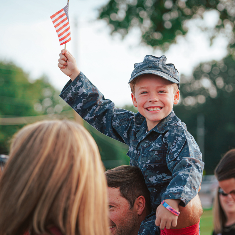 kid holding American flag